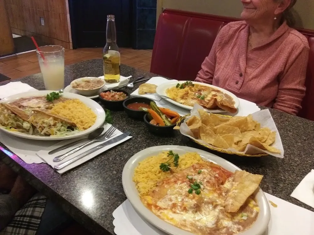 For Ground Is a Chili Relleno Plate Left Is Beef Taco Plate and a Cheese Enchilada Plate